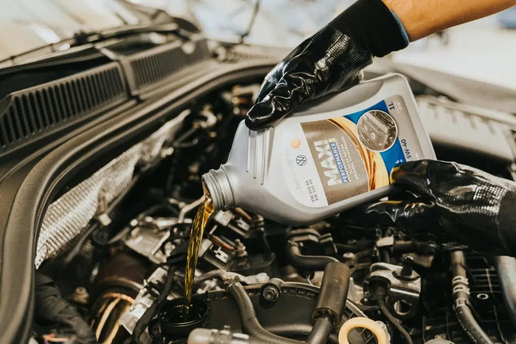 Mechanic performing oil change and routine car maintenance near Bracknell